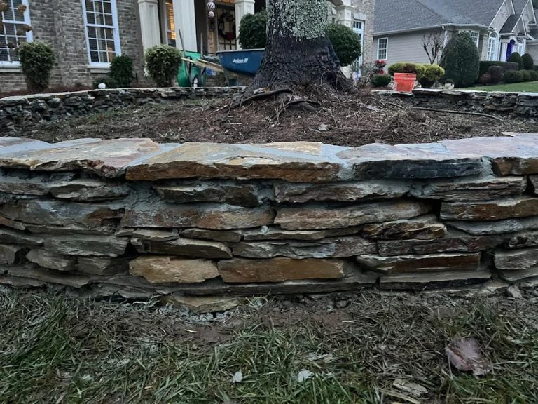 natural stone garden wall on a raised garden bed