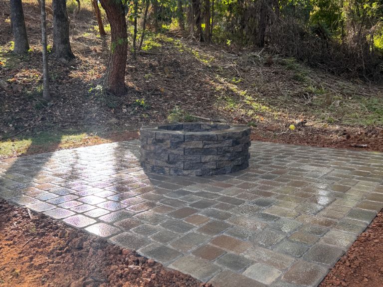 finished custom paver patio in charlotte nc with clean lines and natural surroundings for outdoor entertaining and relaxation