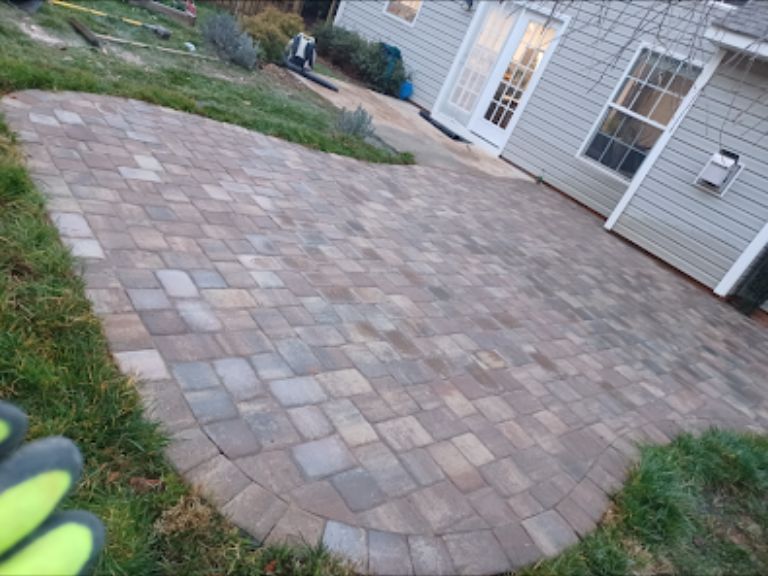 newly paved patio with grass edges mega olde towne paver patio installation in gastonia nc