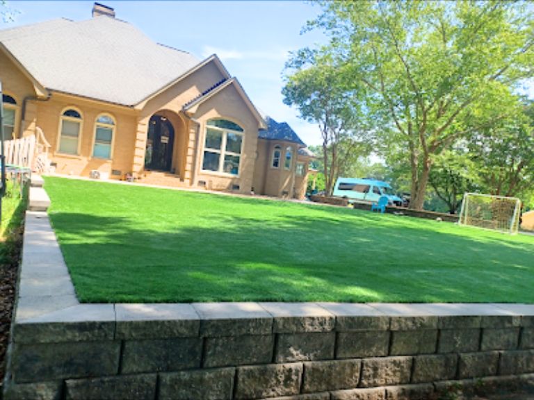 retaining wall in cornelius nc backyard creating level space for outdoor play and soccer

