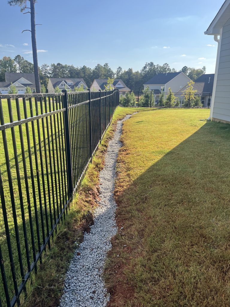 drainage stone surrounding french drain pipe for water filtration in lancaster sc