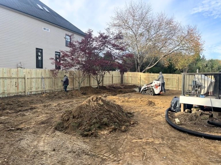 grading a backyard during a artificial turf installation 