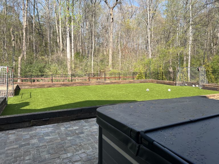 Close-up of artificial turf blade texture and infill at Carmel Commons Fort Mill SC — CLT Pros quality installation detail