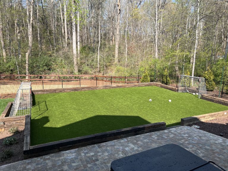 Completed artificial turf surface at Carmel Commons Fort Mill SC with natural-looking blade variation — CLT Pros