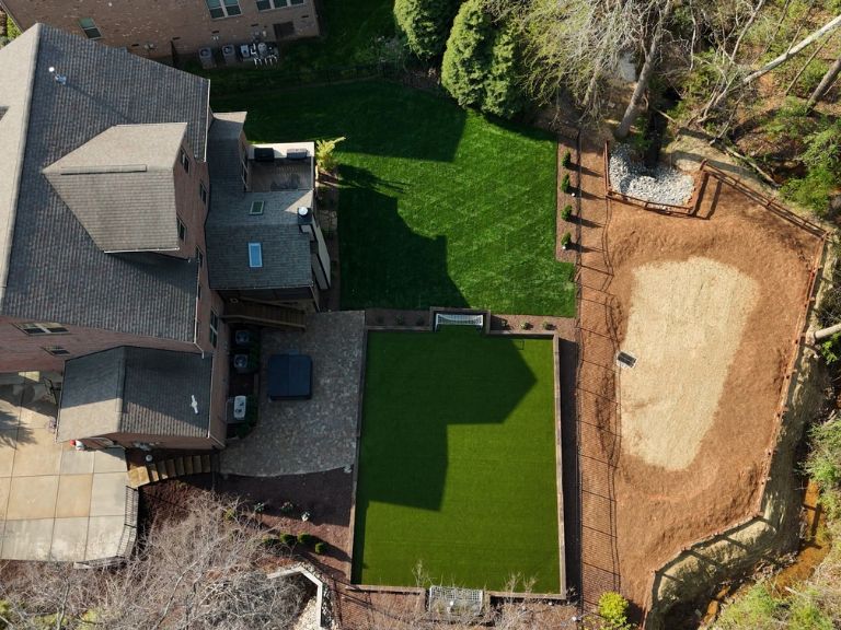 Second aerial drone view of Carmel Commons Fort Mill SC backyard showing full turf coverage and property layout — CLT Pros