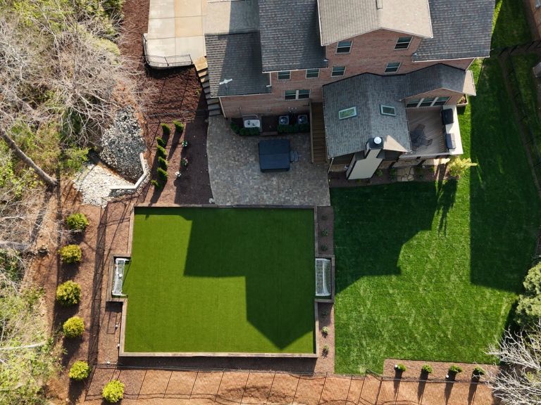 Aerial drone photo of completed artificial turf installation at Carmel Commons Fort Mill SC — CLT Pros full backyard transformation