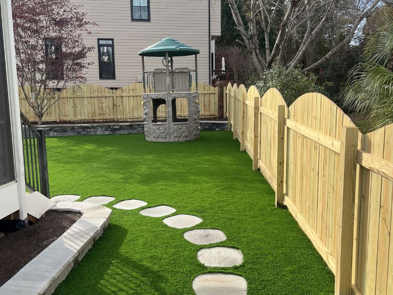 Artificial turf seam and edge finishing detail at Fort Mill SC Providence Square installation by CLT Pros