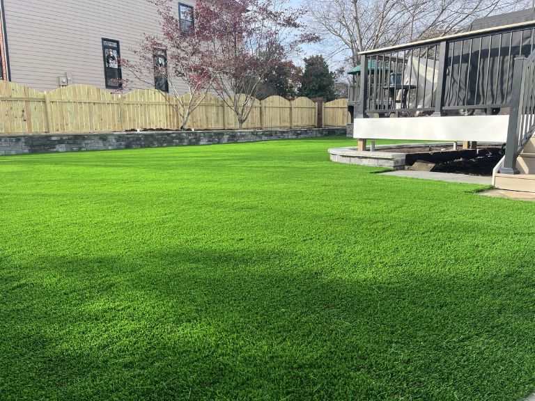 Side yard artificial turf installation at Fort Mill SC Providence Square showing clean turf-to-fence border by CLT Pros
