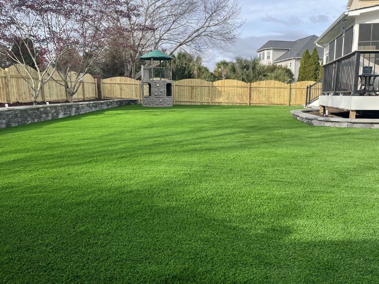 Completed turf surface with stone border and walkway integration at Fort Mill SC Providence Square — CLT Pros