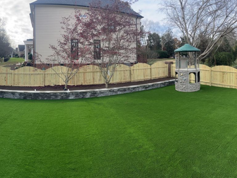 Evening view of Fort Mill SC backyard with installed landscape lighting and artificial turf — CLT Pros Providence Square