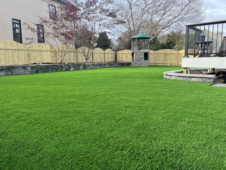Before-and-after style overview shot of Providence Square Fort Mill SC artificial turf and hardscape installation by CLT Pros