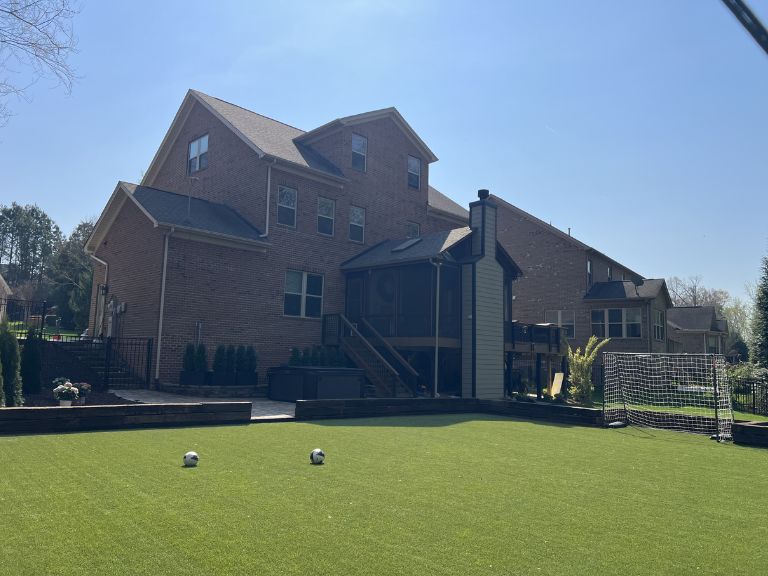 Ground-level view of artificial turf installation at Carmel Commons Fort Mill SC — CLT Pros Purchase Green install