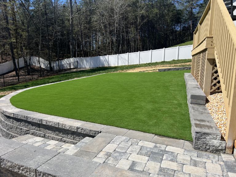 Backyard perimeter view at Roselyn Lancaster SC with artificial turf installed up to fence line — CLT Pros