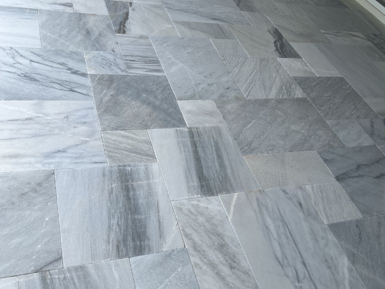 close-up of veined white and gray marble pavers on a finished patio in indian land, sc
