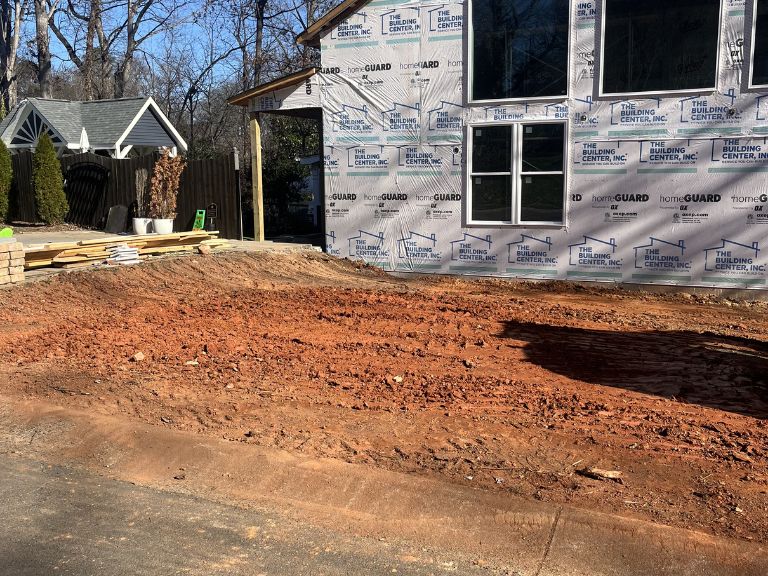 graded and leveled yard beside driveway during grading project in matthews, nc