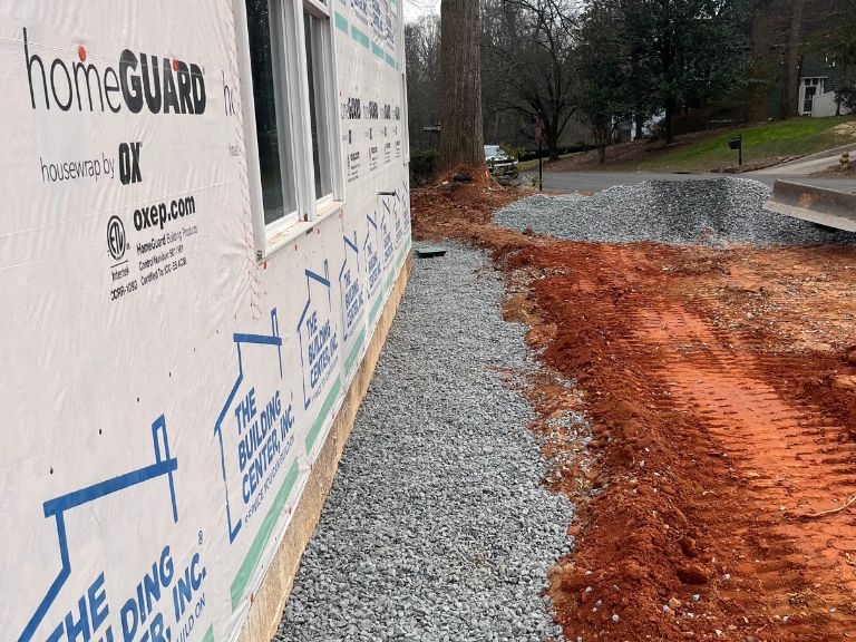 gravel drainage swale graded along foundation wall in matthews, nc
