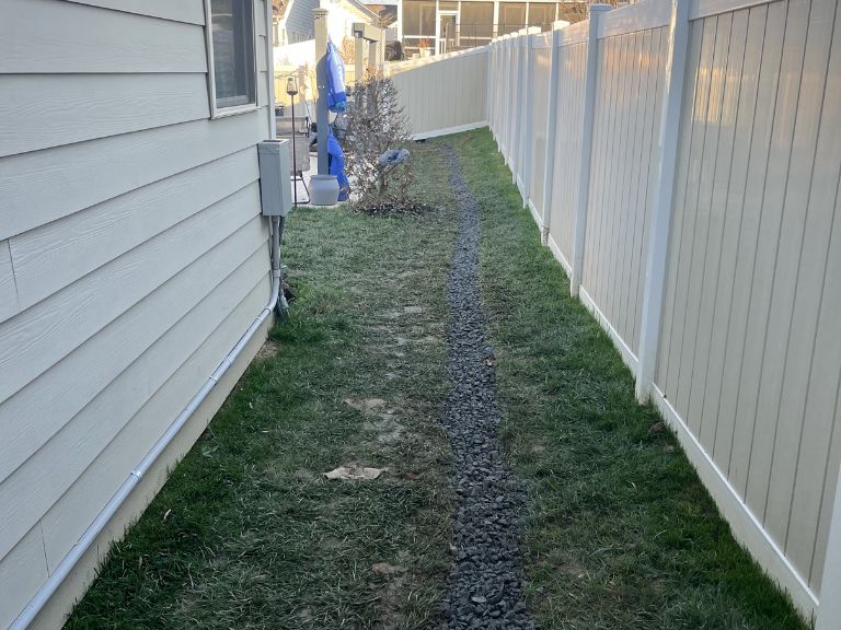 completed gravel-filled trench for french drain system in huntersville, nc