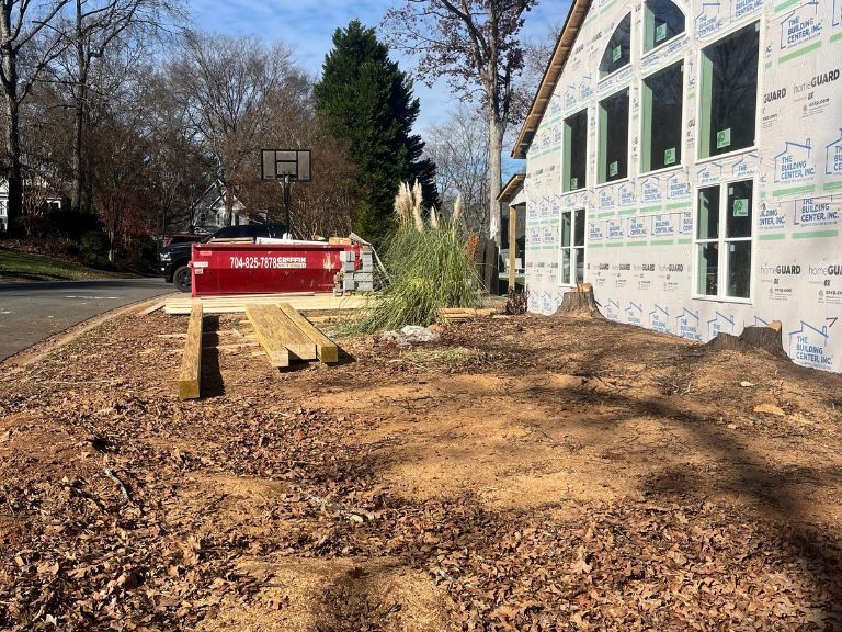 cleared construction yard with dumpster before grading work begins in matthews, nc