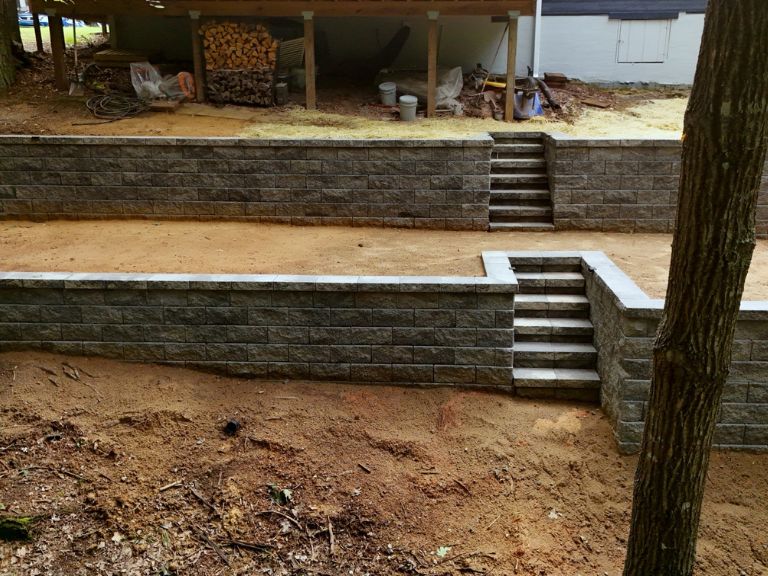 both terraced retaining wall tiers with integrated steps shown from side angle in tega cay sc — clt pros completed installation