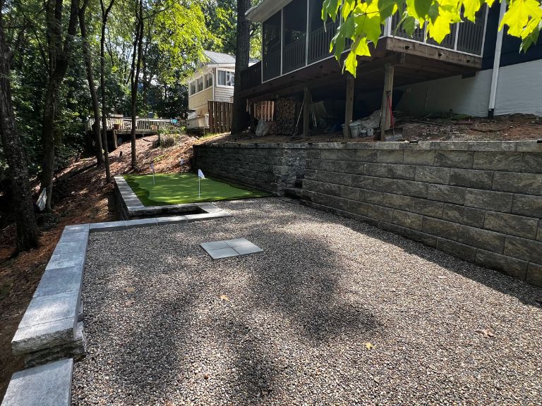 completed tega cay sc phase 2 — pea gravel patio and artificial turf putting green installed between terraced retaining walls — clt pros