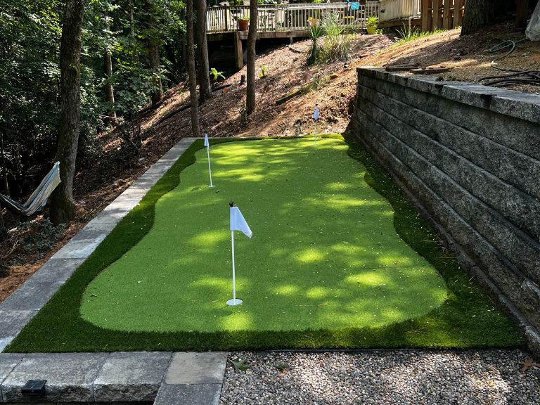 Custom artificial turf putting green and terraced granite retaining wall in Tega Cay SC — CLT Pros York County