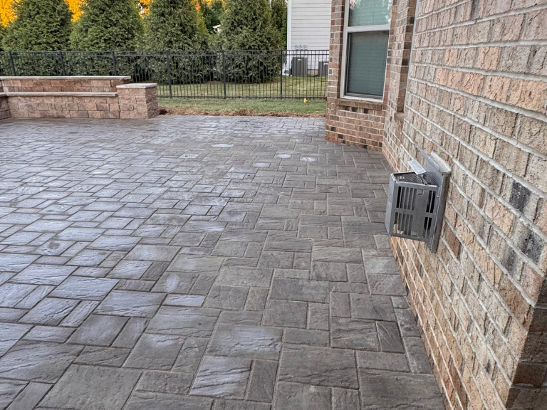 paver patio running along the brick wall of the house in weddington, nc