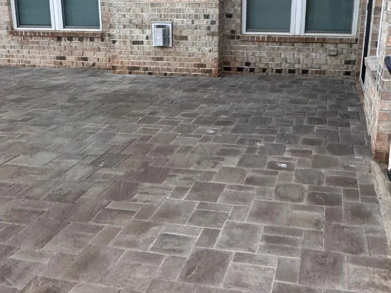 close view of the gray paver patio surface against the brick foundation in weddington, nc