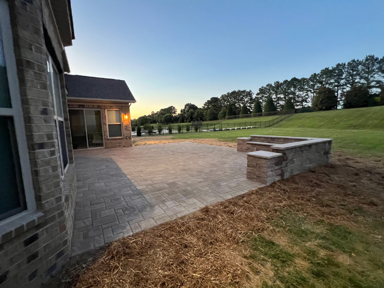 Completed paver patio with segmental block seating wall in Weddington NC — CLT Pros Union County hardscaping