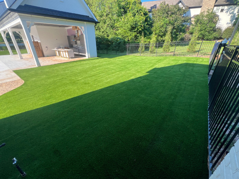 artificial turf lawn in late-day shade toward the pool house in weddington, nc