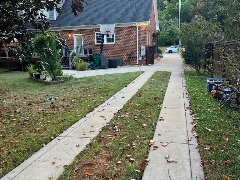 concrete ribbon driveway strips crossing the lawn before the driveway extension in grier heights, charlotte, nc
