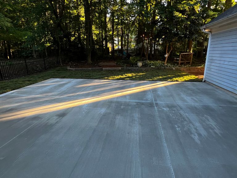 new 800 sq ft concrete patio between the house and detached garage in huntersville, nc