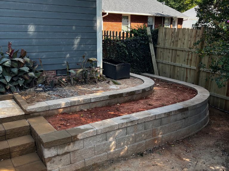 curved segmental block retaining wall with built-in steps and a tiered planter in grier heights, charlotte, nc