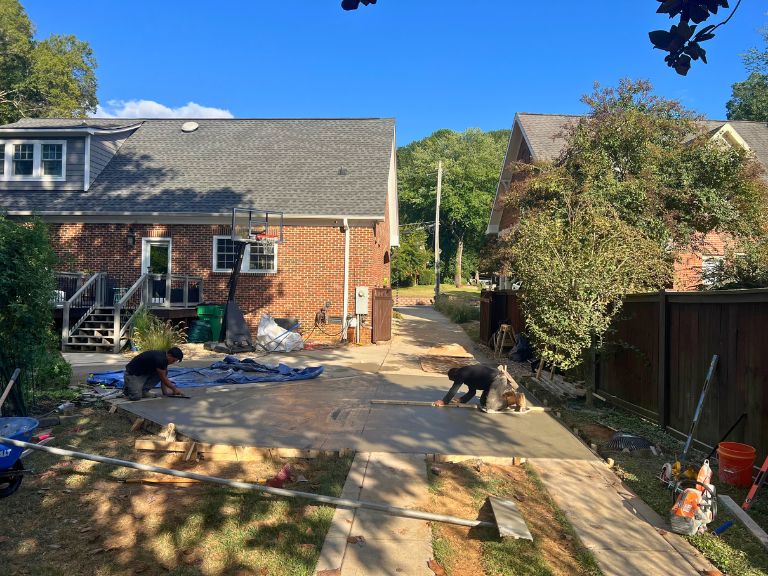 clt pros crew screeding and finishing fresh concrete on the driveway extension in grier heights, charlotte, nc