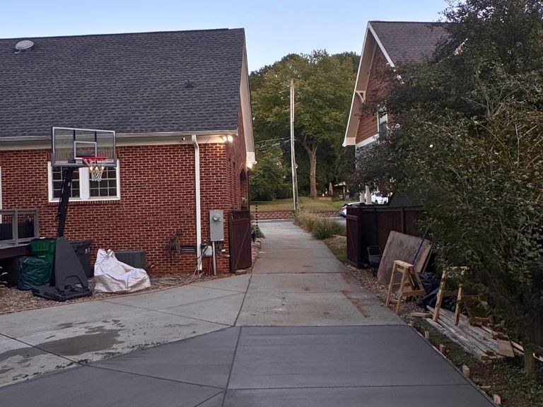 freshly finished concrete driveway extension at dusk in grier heights, charlotte, nc