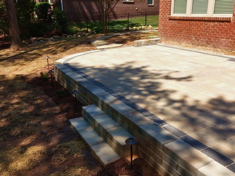 segmental retaining wall corner with paver steps and low-voltage path lights in indian land, sc